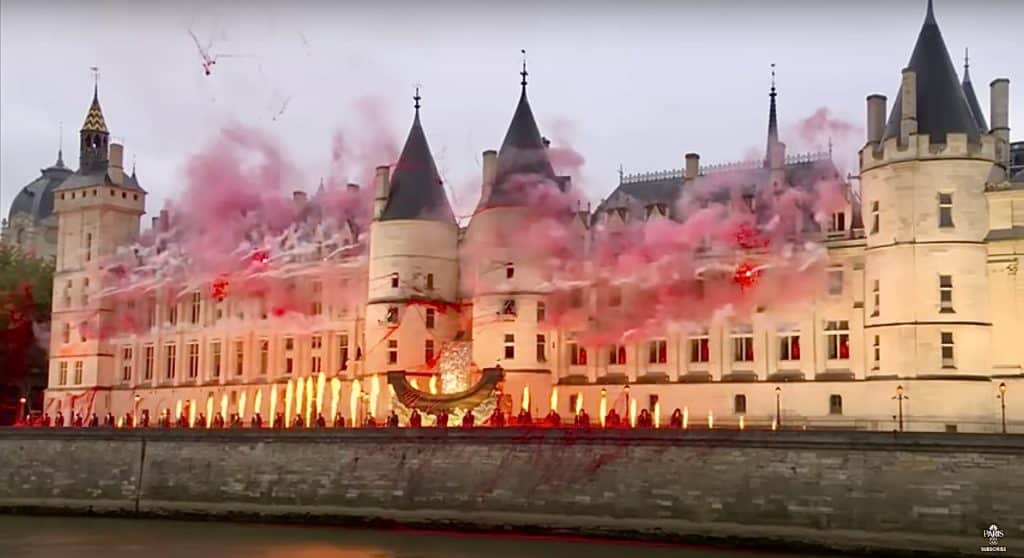 Pyrotechnics and red smoke can be seen in front of Paris' Conciergerie palace as part of Gojira's performance during the opening ceremony.